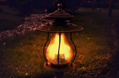 Close-up of illuminated lantern on field