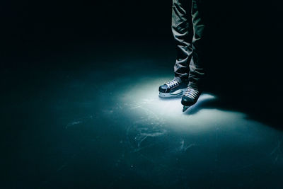 Low section of person standing on ice rink