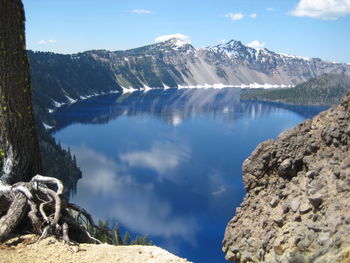 Scenic view of mountains against blue sky