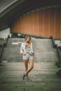 Full length of woman walking on footpath