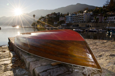 Close-up of boats moored at harbor against sky