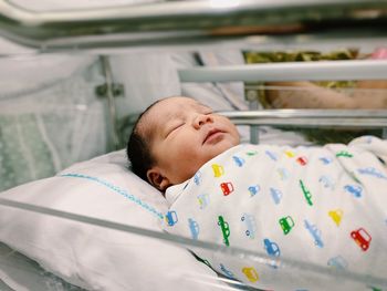 Cute baby sleeping in incubator