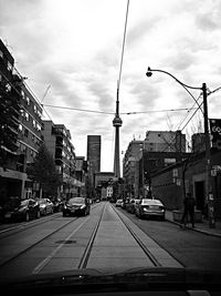 City street and buildings against sky