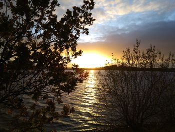 Scenic view of lake at sunset