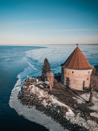 The tower of an ancient fortress on the background of lake ladoga