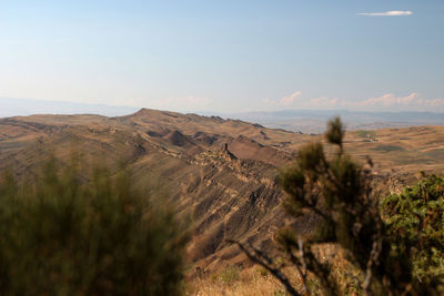 Scenic view of arid landscape against sky