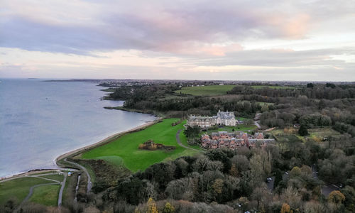 High angle view of buildings by sea against sky