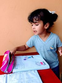 Cute girl studying on table