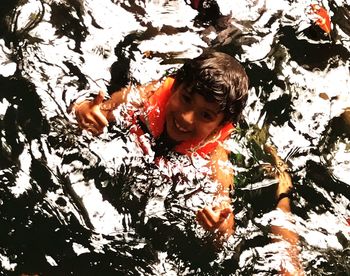 High angle view of boy swimming in sea