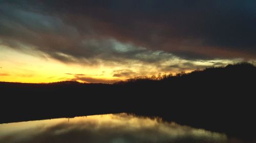 Scenic view of silhouette trees against sky at sunset