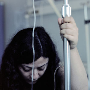 Close-up of woman by iv drip at hospital