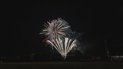 Low angle view of firework display at night