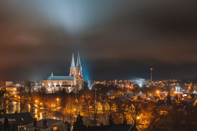 High angle view of city lit up at night