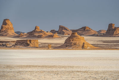 Rock formations in desert against sky