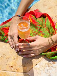 Midsection of woman drinking glass