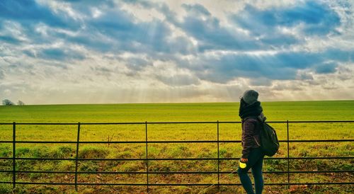 Rear view of man looking at field