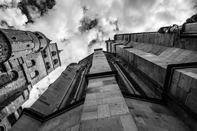 Low angle view of building against cloudy sky