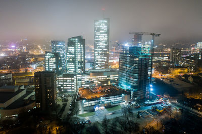 High angle view of illuminated buildings in city at night