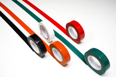 High angle view of multi colored adhesive tapes stuck on gray background