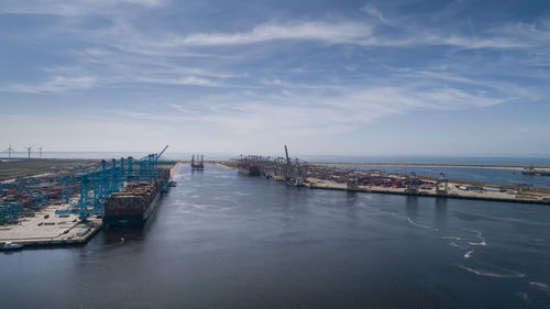 Scenic view of harbor by sea against sky