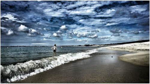 Scenic view of sea against cloudy sky