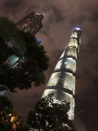 Low angle view of illuminated building against sky at night