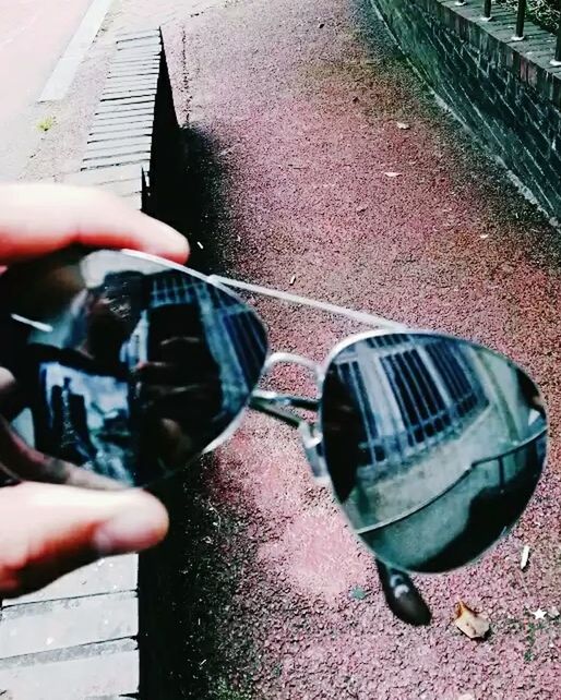 CLOSE-UP OF MAN HOLDING UMBRELLA