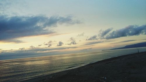 Scenic view of beach against sky during sunset