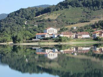 Reflection of trees and buildings on mountain