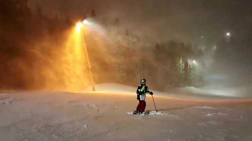 Rear view of man on snow against sky