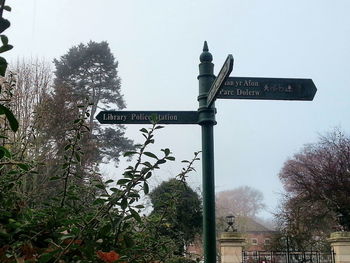 Low angle view of road sign against clear sky