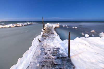 Scenic view of sea against sky during winter