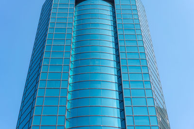 Low angle view of modern building against clear blue sky