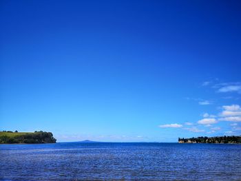 Scenic view of sea against clear blue sky