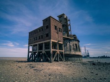 Low angle view of abandoned building against sky