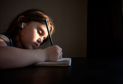 Portrait of boy on table at home