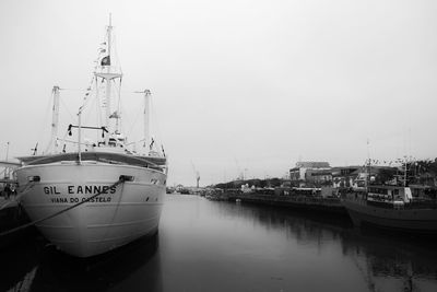 Ship moored at harbor against clear sky