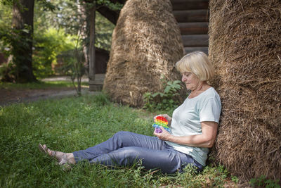 Rear view of woman sitting at park