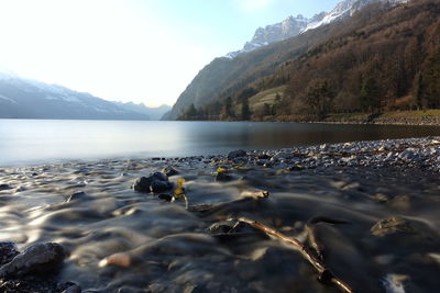 Scenic view of lake and mountains against sky