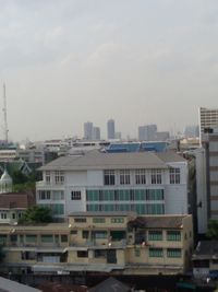 Residential buildings against cloudy sky