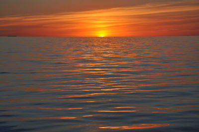 Scenic view of sea against orange sky