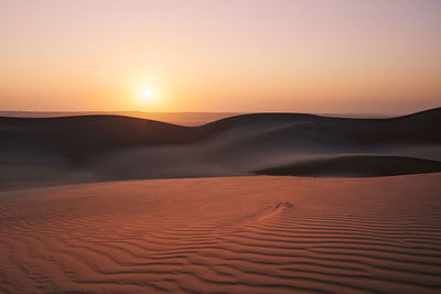 Sand dunes against sky at sunrise. desert wahiba sands in sultanate of oman.