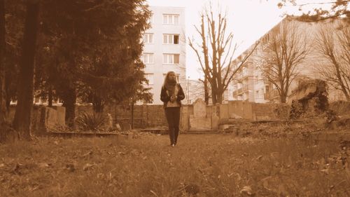 Full length of woman standing by railing