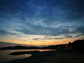 Scenic view of silhouette trees against sky at sunset