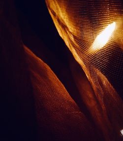 Close-up of illuminated lamp against black background