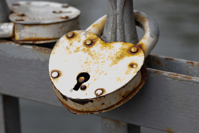 Close-up of padlock on rusty metal