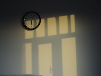 Low angle view of clock on wall