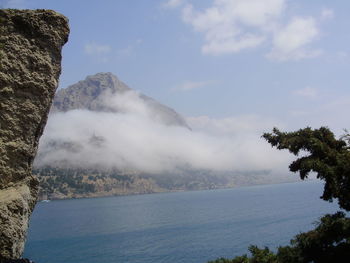 Scenic view of sea and mountains against sky