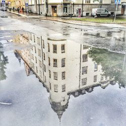Reflection of buildings in puddle
