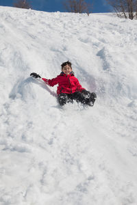 Cheerful boy playing on snow